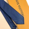 Blue silk tie with tonal geometric pattern and light blue detailing near the tip
