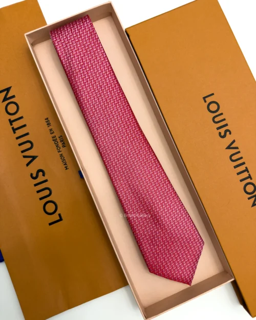 Raspberry red silk tie with repeating pink and white geometric pattern