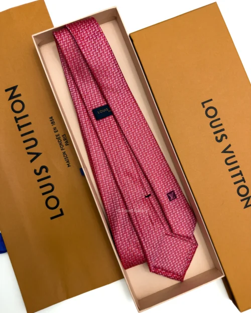 Raspberry red silk tie with repeating pink and white geometric pattern