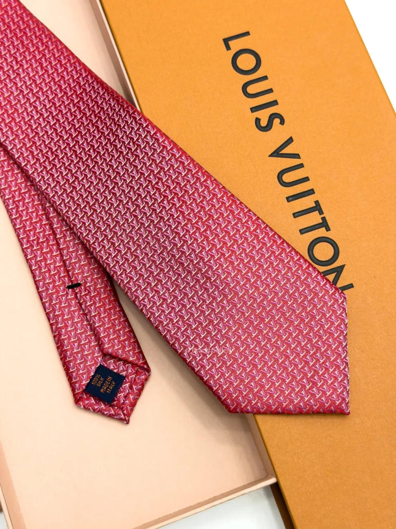 Raspberry red silk tie with repeating pink and white geometric pattern
