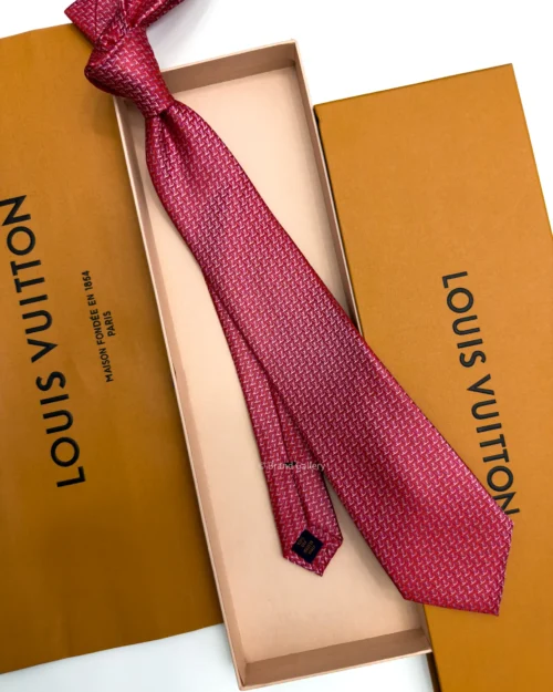 Raspberry red silk tie with repeating pink and white geometric pattern