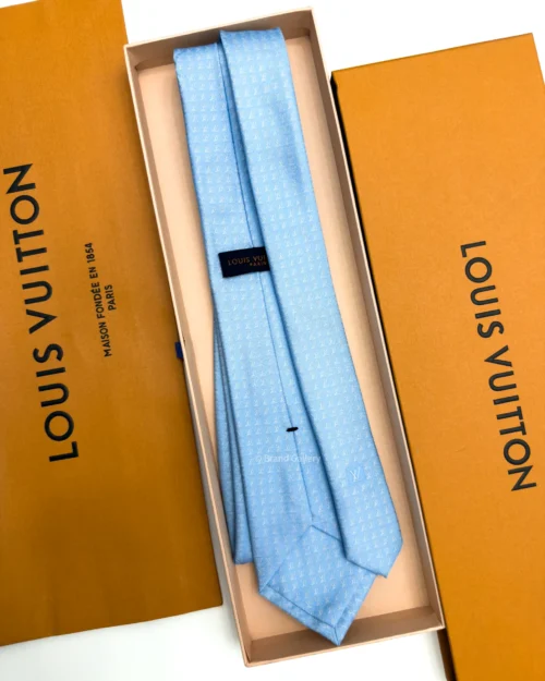 Sky blue silk tie with repeating white geometric micro-pattern