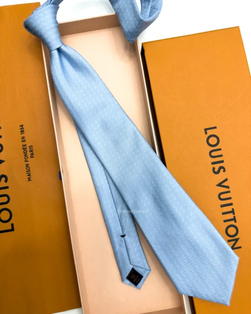 Sky blue silk tie with repeating white geometric micro-pattern