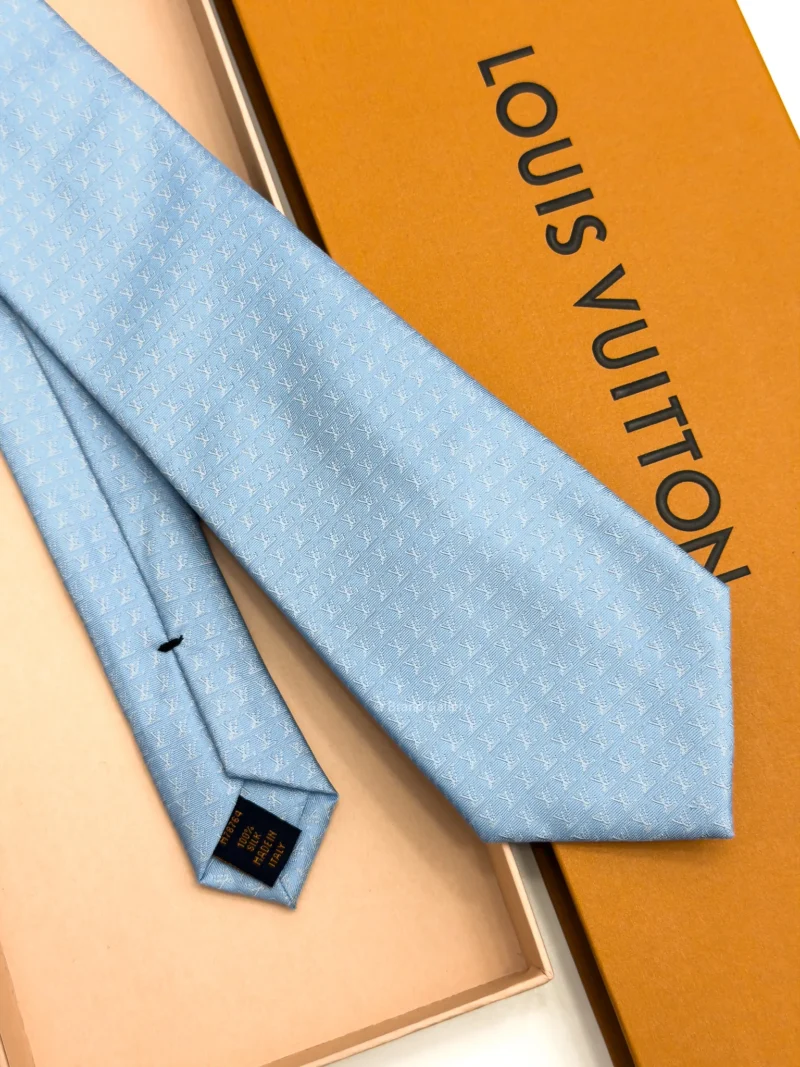 Sky blue silk tie with repeating white geometric micro-pattern
