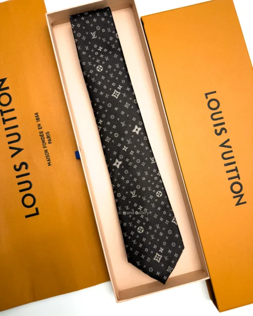 Dark brown silk tie with repeating light beige geometric pattern and textured weave